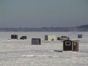 Guys sit in these boxes in sub-zero temperatures to catch fish. And drink beer.